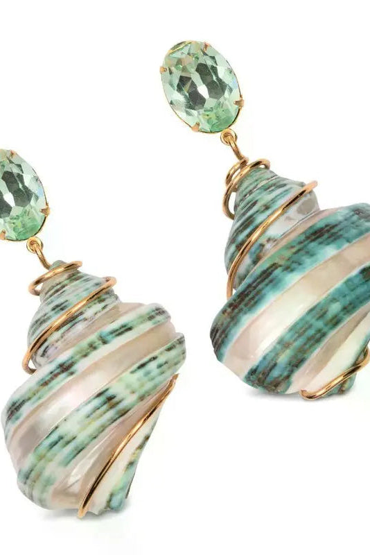 Close-up of Jennifer Behr Wave Earrings showcasing green crystal studs and natural spiral shell pendants wrapped in gold-tone wire.