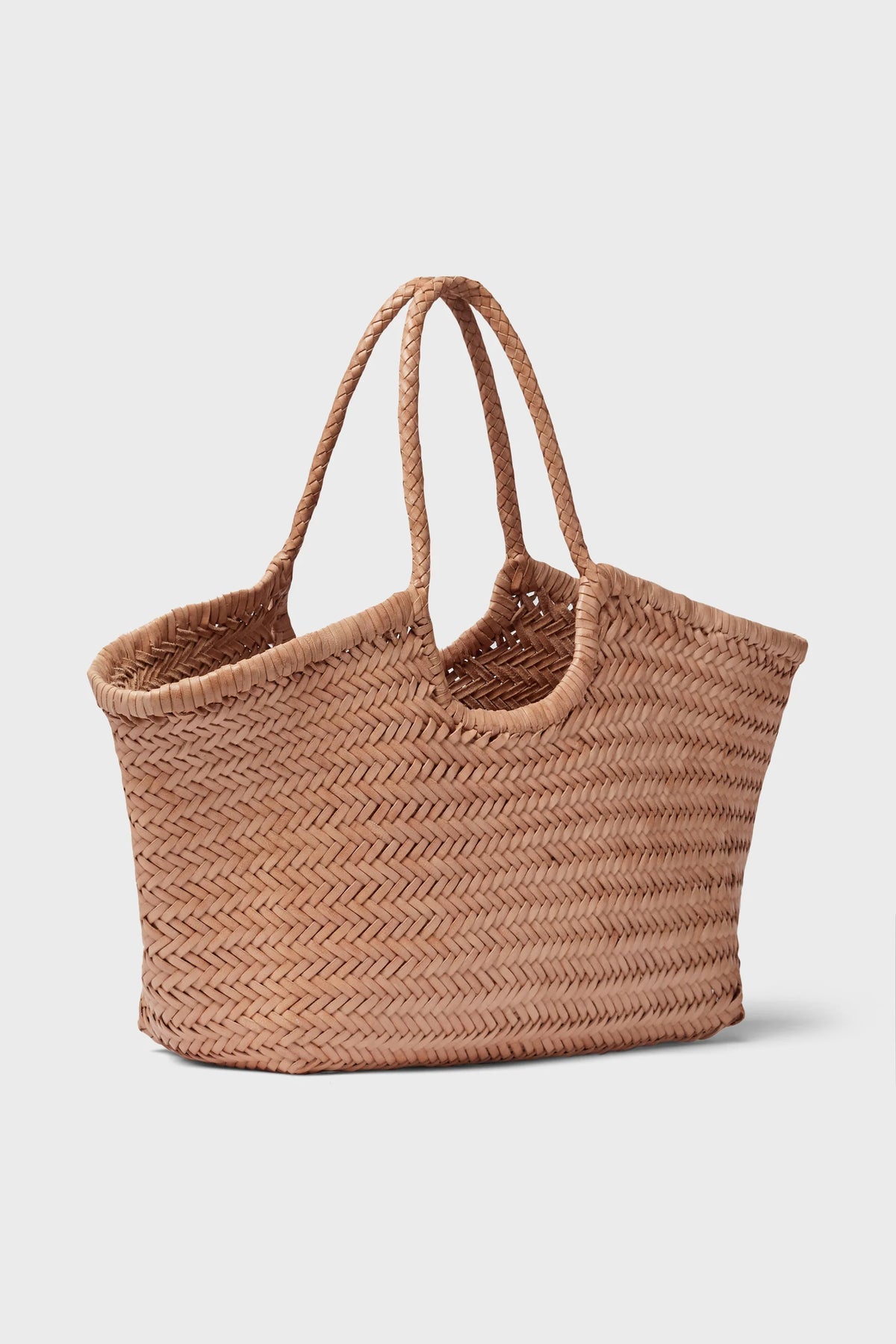 Angled view of the natural handwoven leather tote with braided handles.
