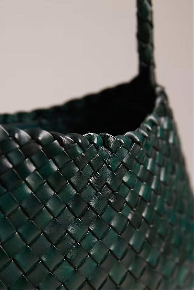Close-up of the Rosalia bag’s forest-green woven leather texture.