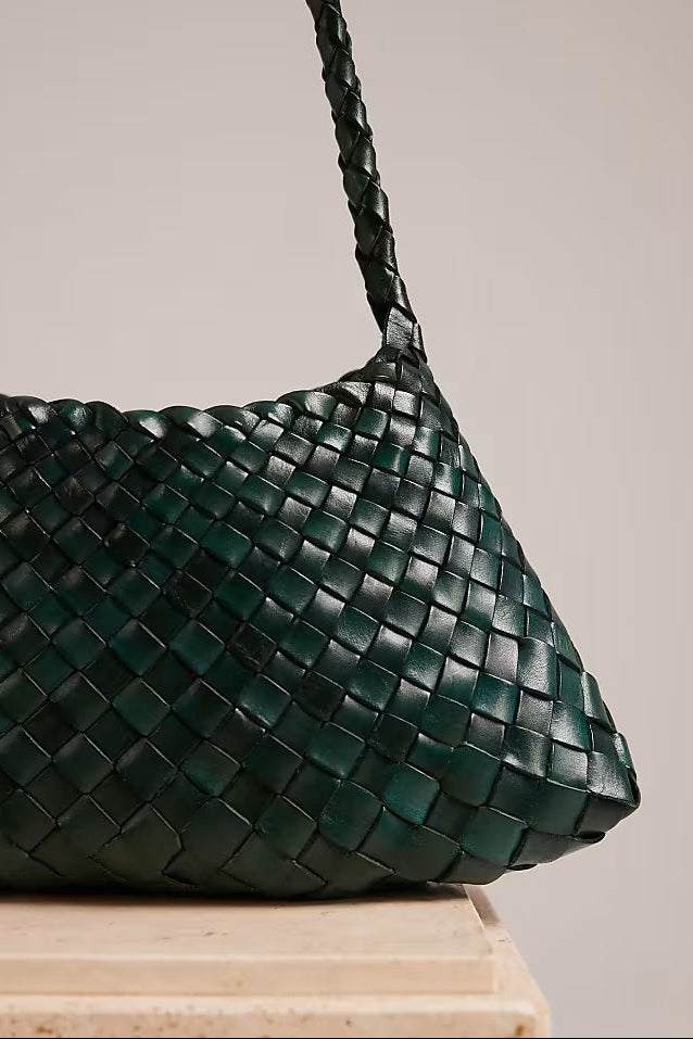 Close-up of the forest-green bag’s woven construction and shoulder strap.