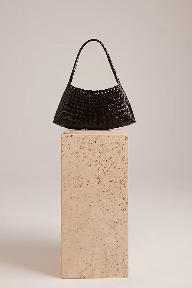 Dark-brown Rosalia Shoulder Bag displayed on a stone pedestal.