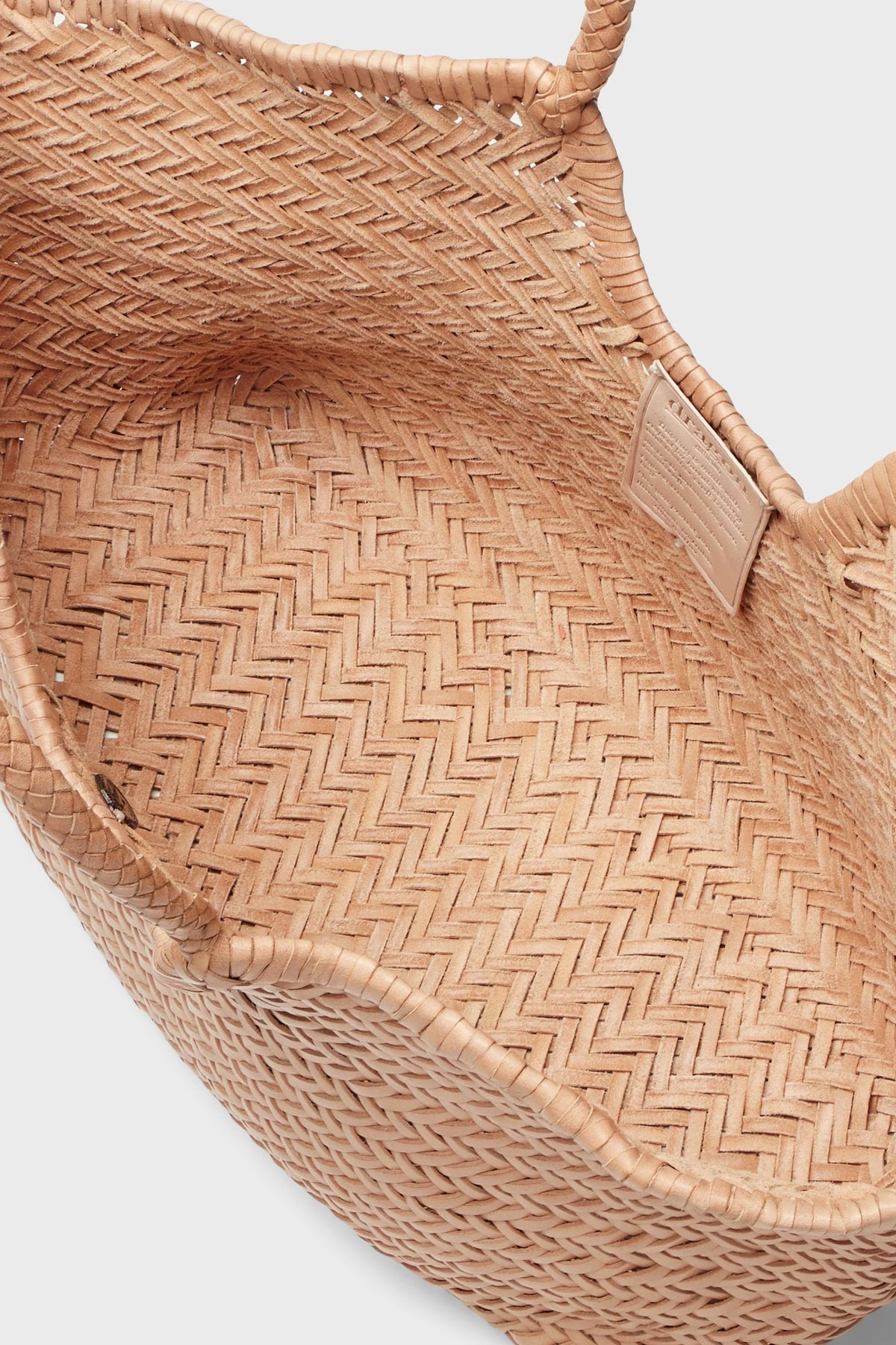 Interior close-up of the Dragon Diffusion Nantucket Large Tote in natural handwoven leather.