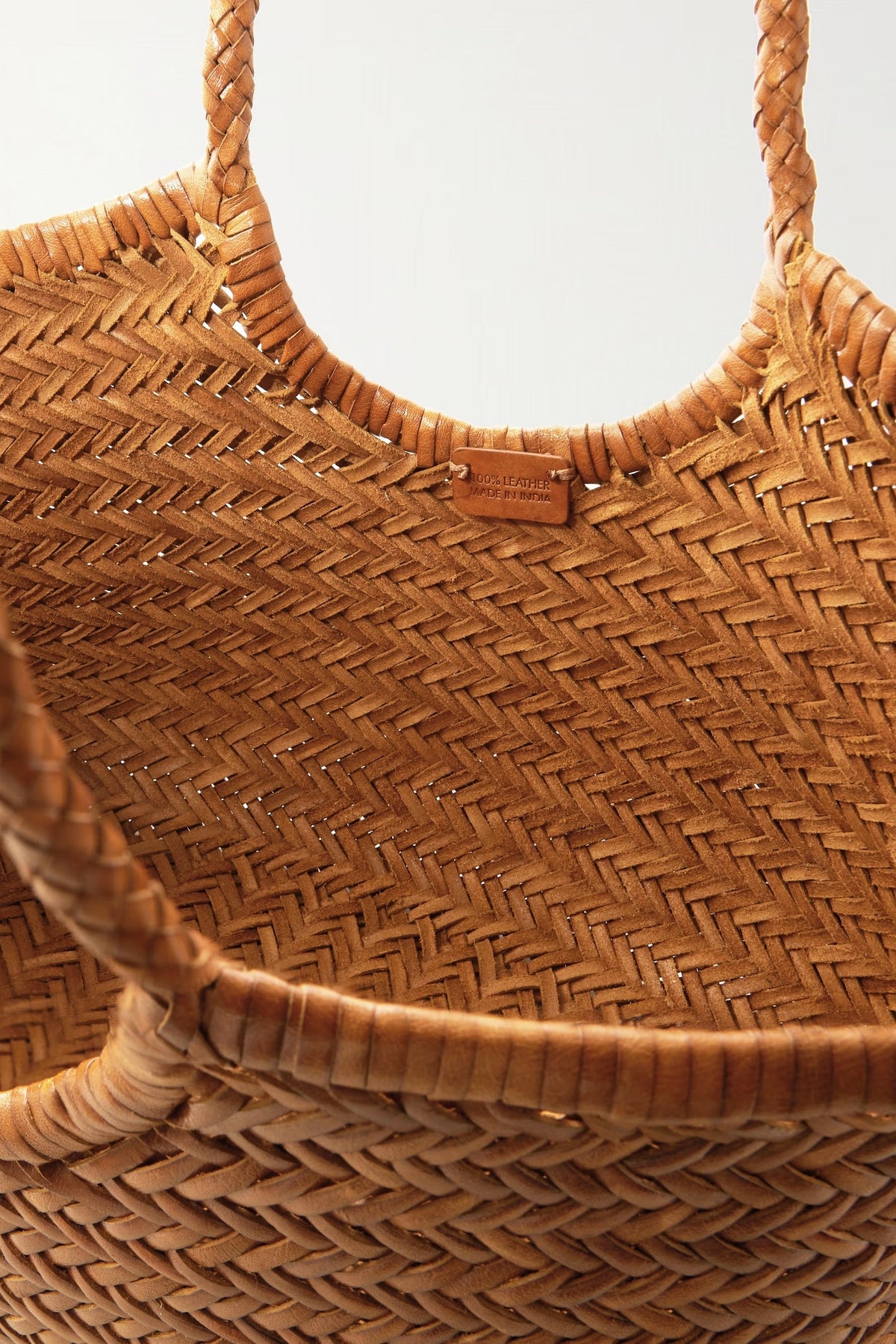 Interior view of the tan handwoven leather tote with Dragon Diffusion label.