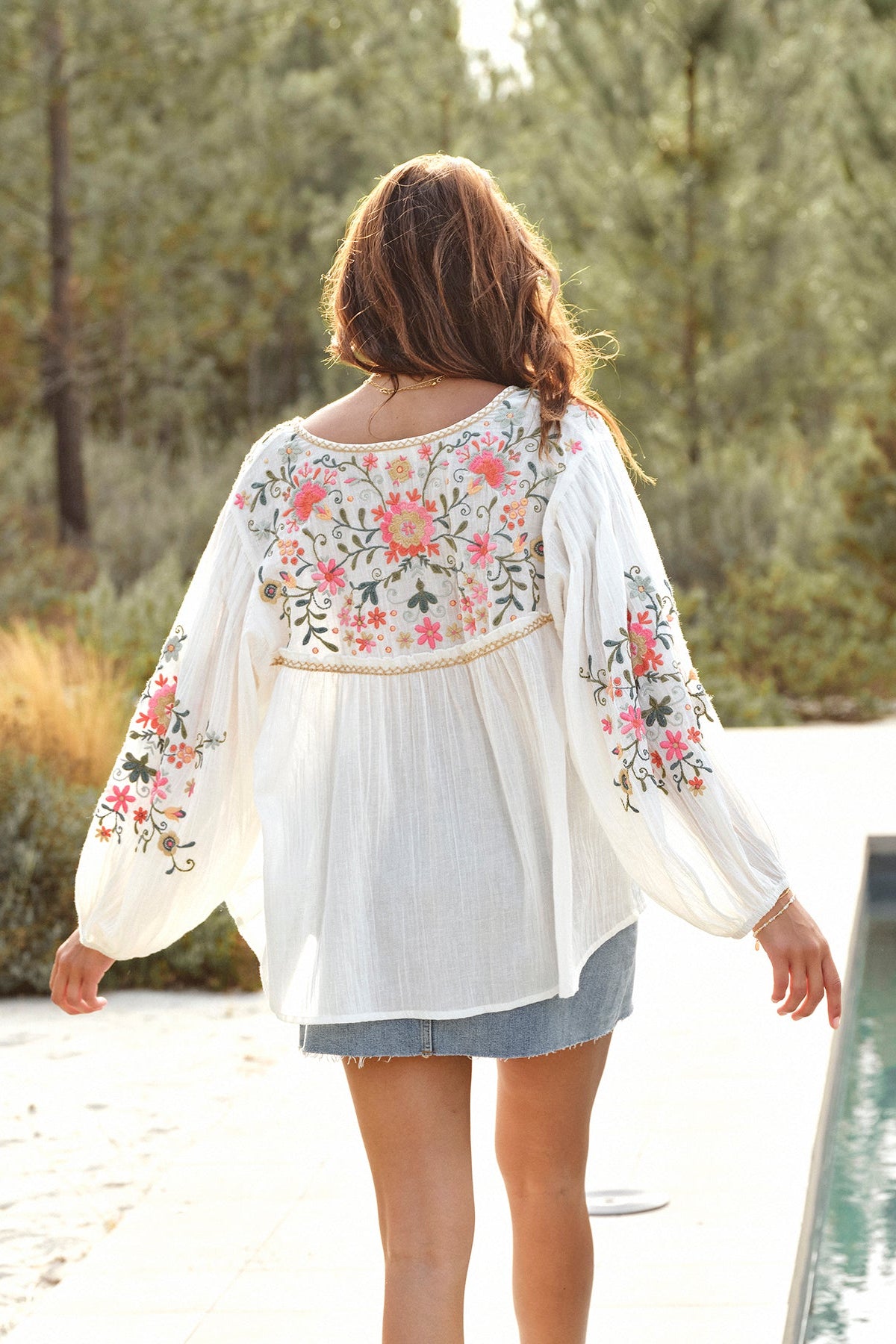 Back view of M.A.B.E Loren relaxed embroidered blouse in textured cotton