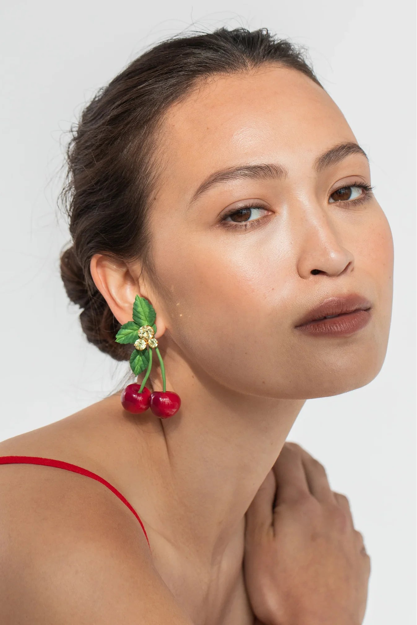 Model wearing Jennifer Behr Maraschino Earrings styled with a minimalist look to highlight the statement silhouette.