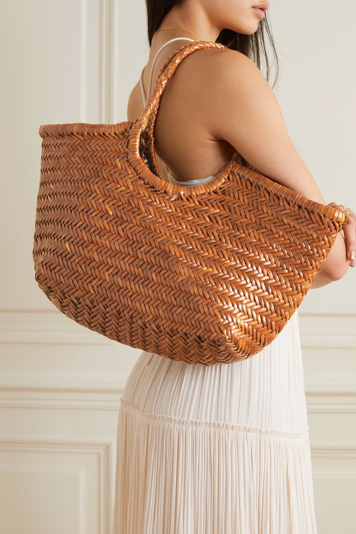 Model carrying the Dragon Diffusion Nantucket Large Tote in tan over her shoulder.