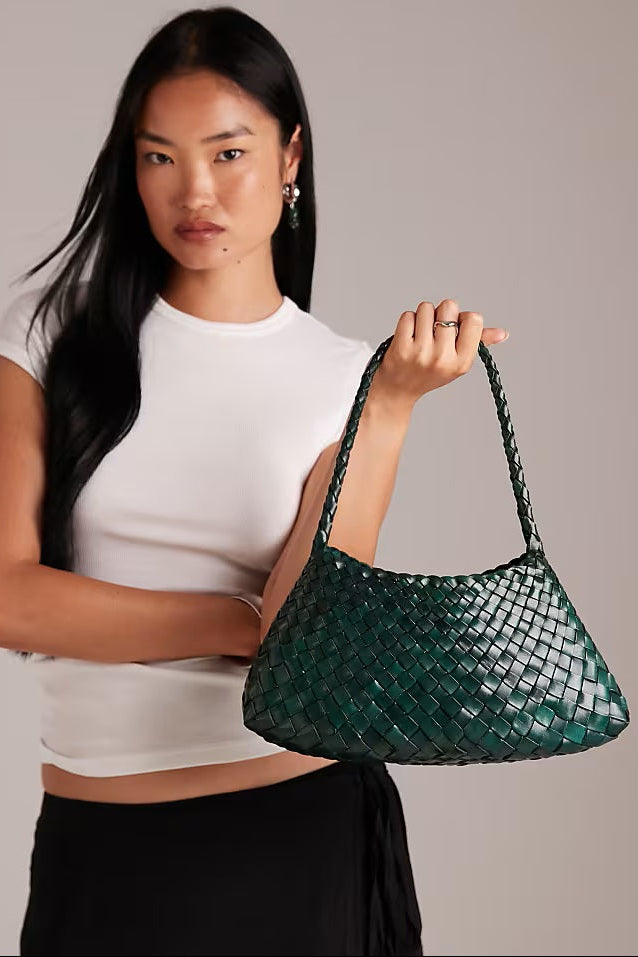 Model carrying the Rosalia Shoulder Bag in forest green.
