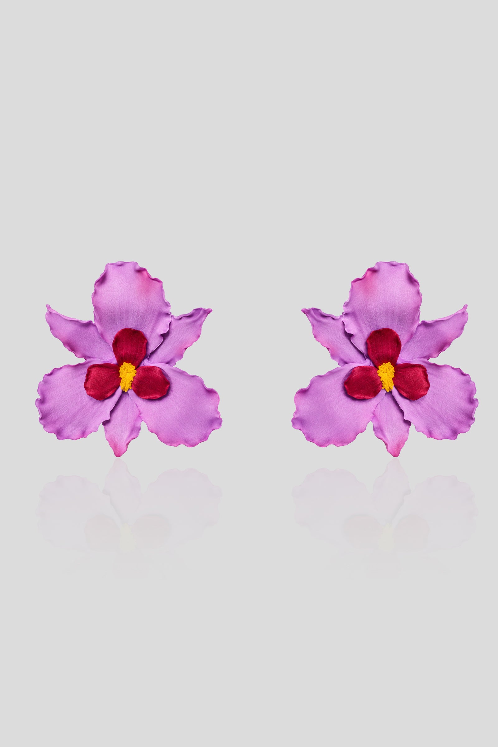 Mulberry Bloom Earrings handcrafted from polymer clay with lilac petals, wine-red accents, and a yellow center.