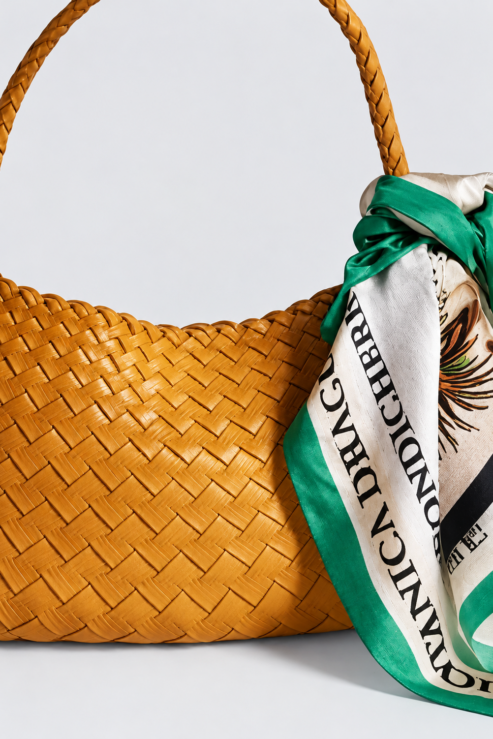Rosalia Medium woven leather shoulder bag in golden yellow, styled with a green printed scarf.