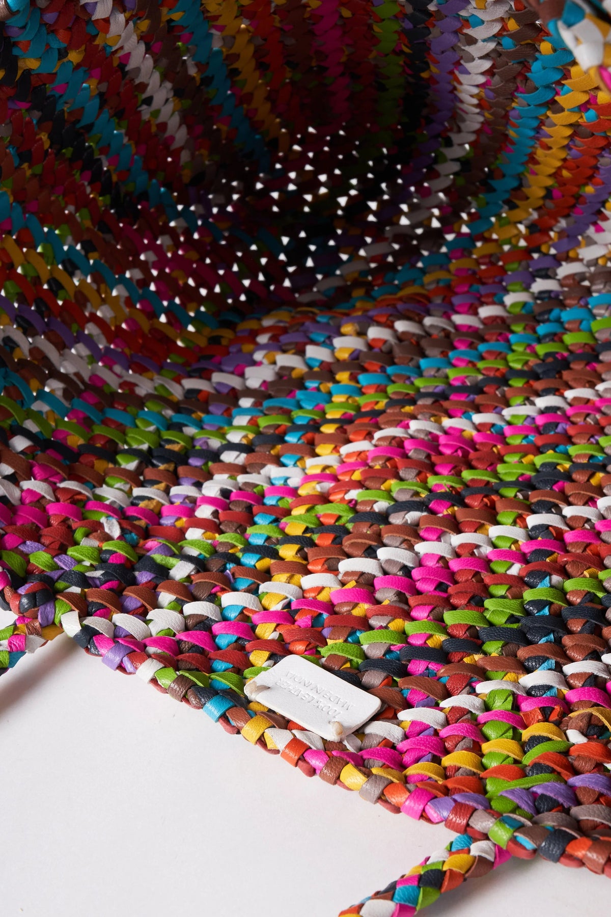 Interior view of the unlined Octo Multi leather tote showing its colourful hand-knotted construction.