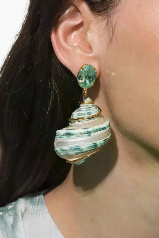 Detailed side view of Jennifer Behr Wave Earrings worn by a model, featuring natural spiral shells and green crystal accents.