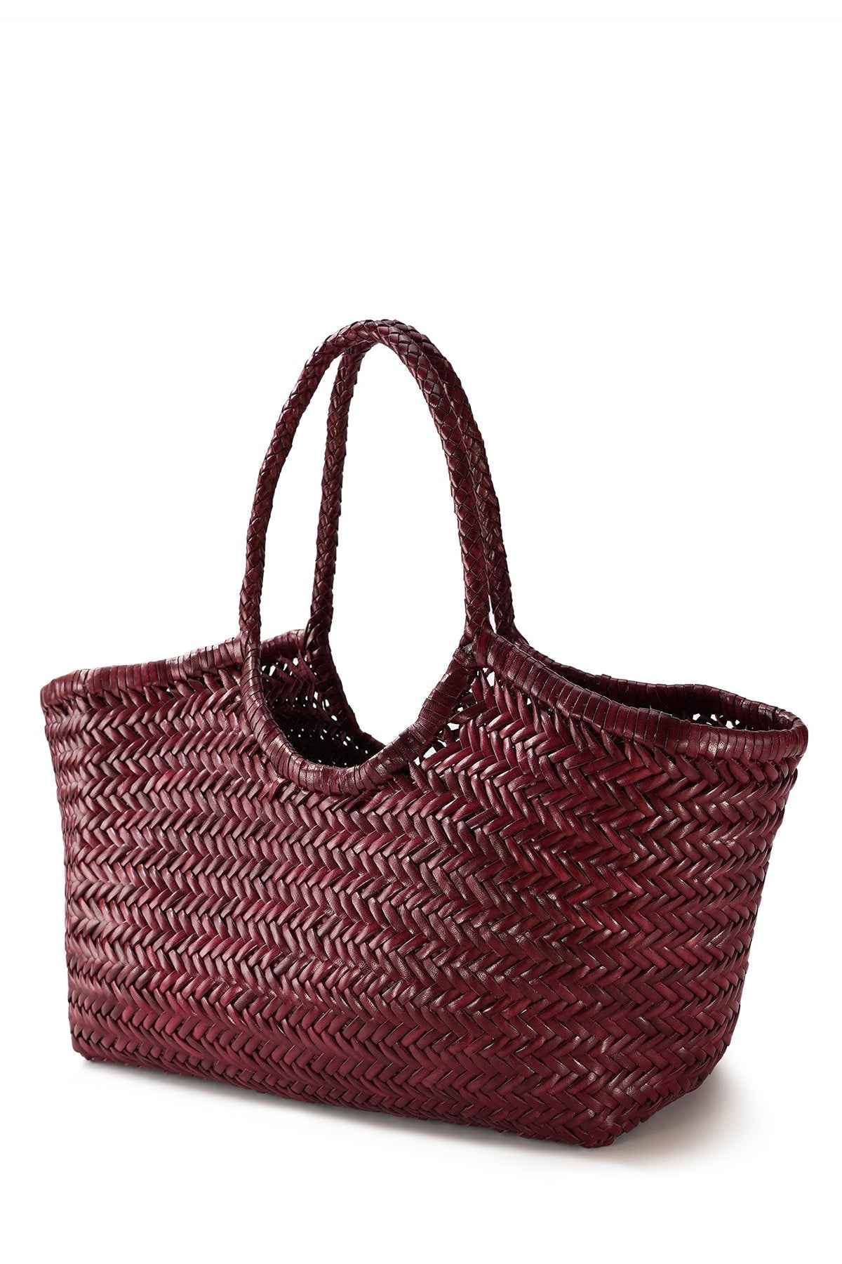 Angled side view of the bordo Nantucket Large Tote with braided leather handles.