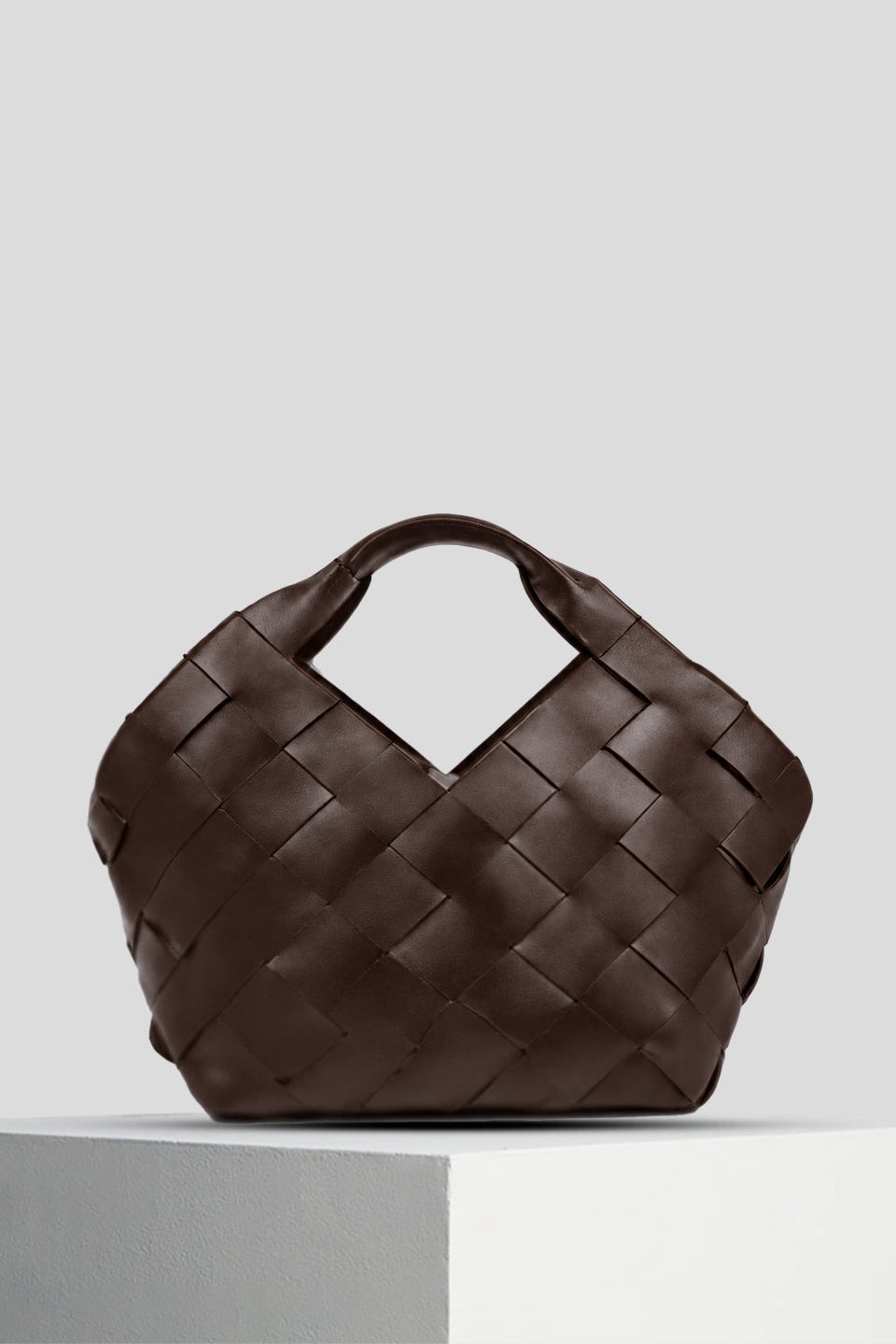 Dragon Diffusion Botteghe bucket bag reference showing its hand-held silhouette and woven leather construction.
