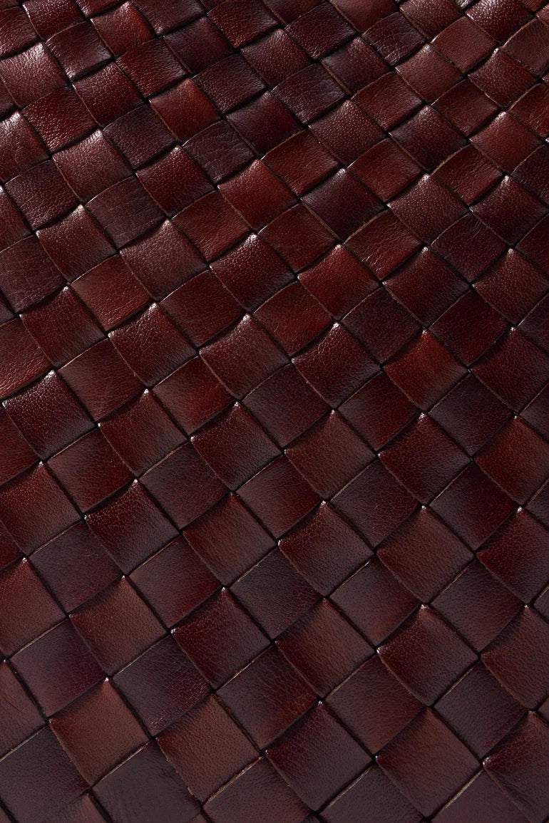 Close-up of the bruciato tote’s handwoven leather texture.