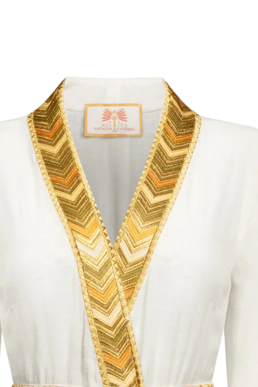 Close-up of the ochre and gold gradient trim and deep V-neckline on the Natacha & Vanessa Livia Maxi Dress.