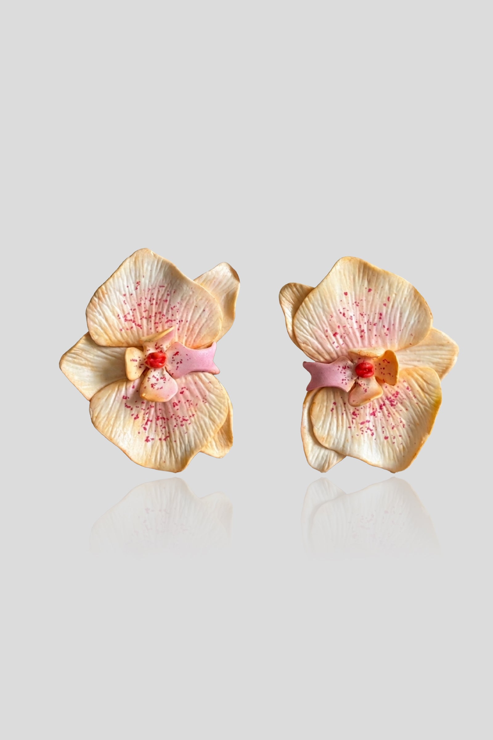 Freckle Blush Earrings featuring handcrafted orchid blooms in butter yellow with blush pink accents and delicate freckled detailing.