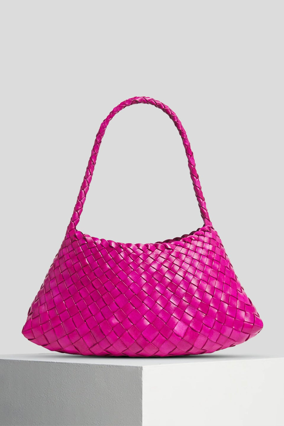 Fuchsia Rosalia Shoulder Bag displayed on a white pedestal.