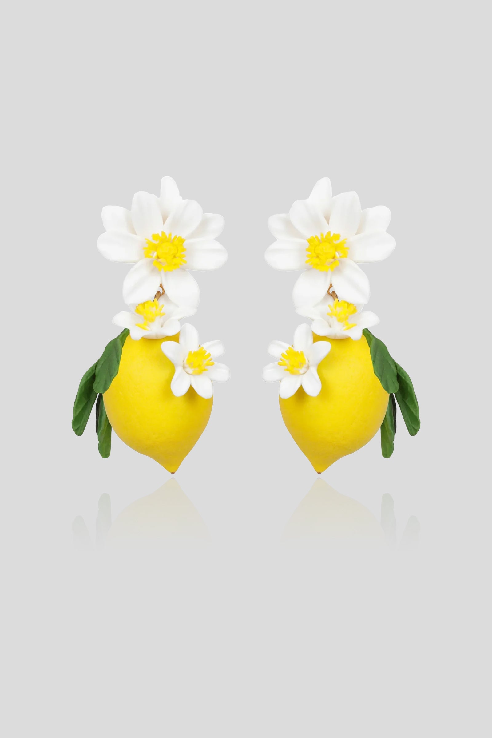Jennifer Behr Limoncello Earrings featuring hand-sculpted lemons, white blossoms, and green leaves.