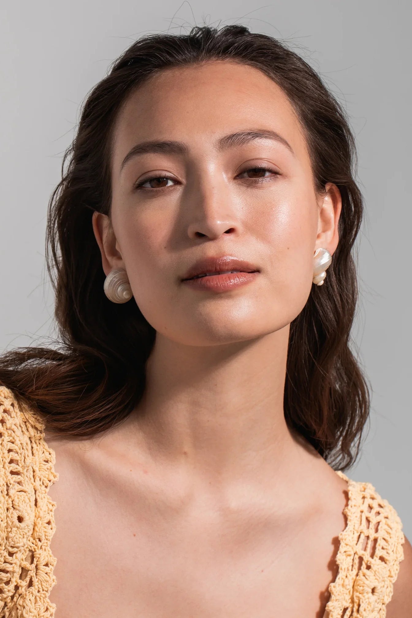 Front view of Jennifer Behr Luca Earrings crafted from natural spiral turbo mollusc shells.