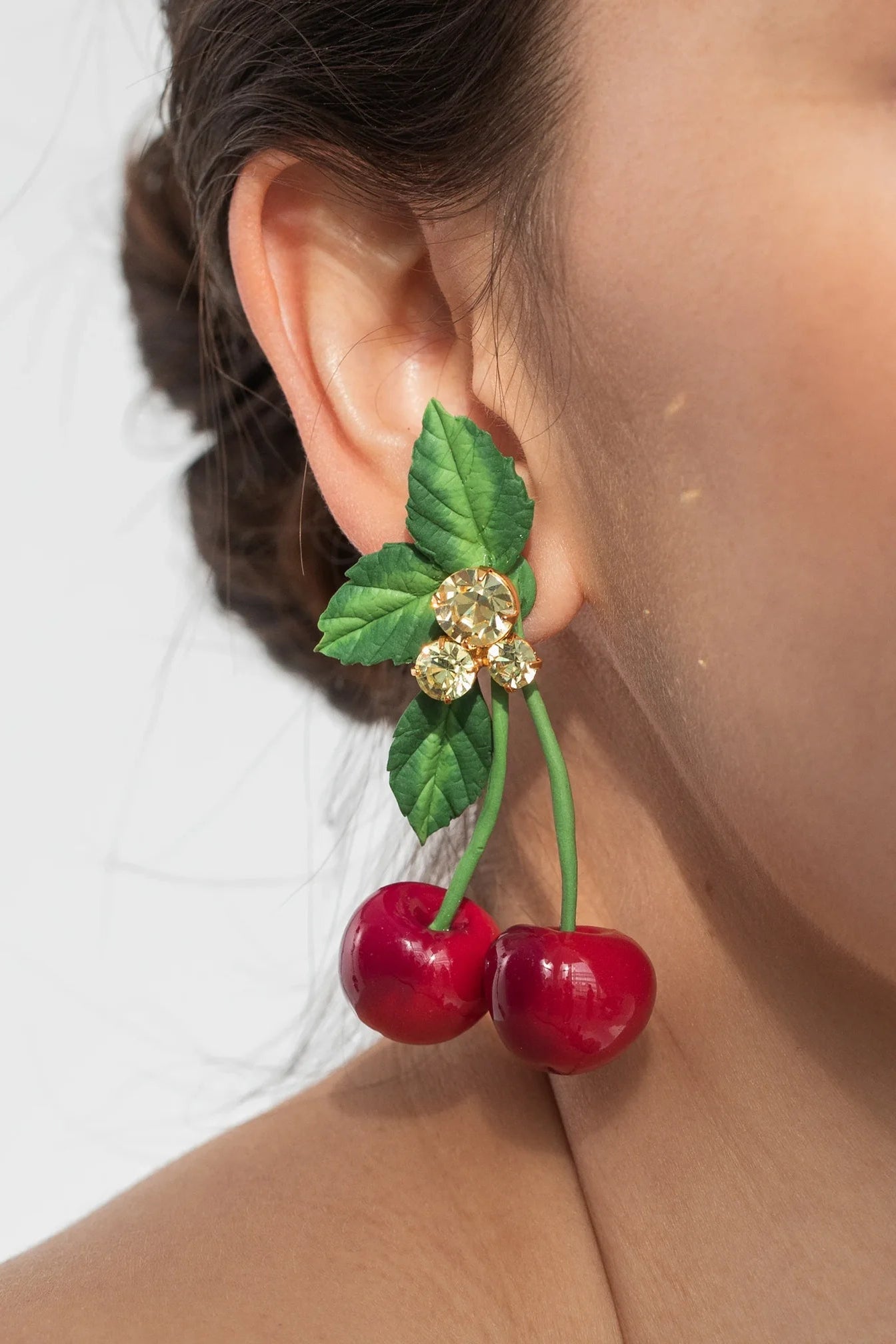 Model wearing Jennifer Behr Maraschino Earrings styled with a minimalist look to highlight the statement silhouette.