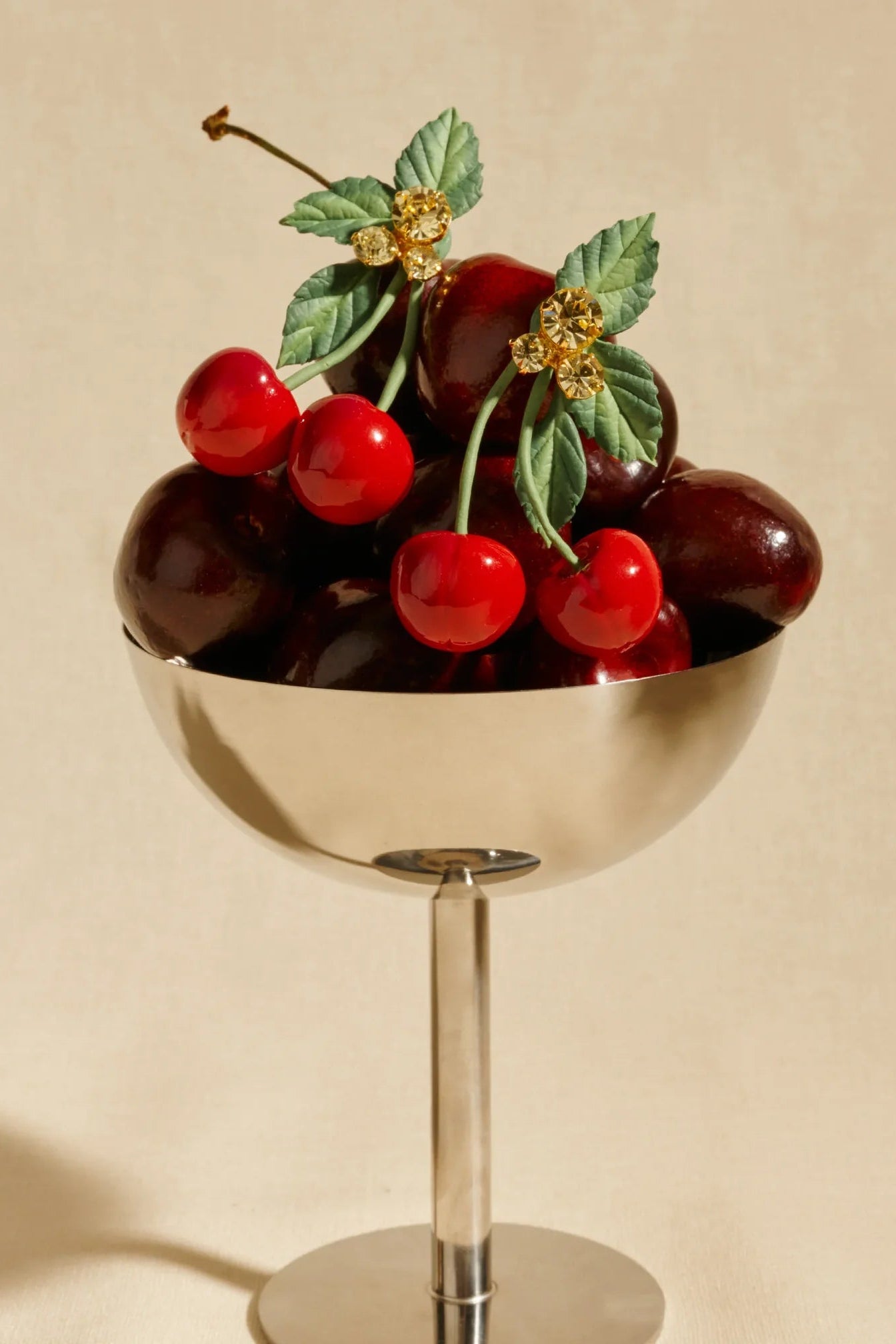 Jennifer Behr Maraschino Earrings displayed with fresh cherries, highlighting the playful handcrafted inspiration.