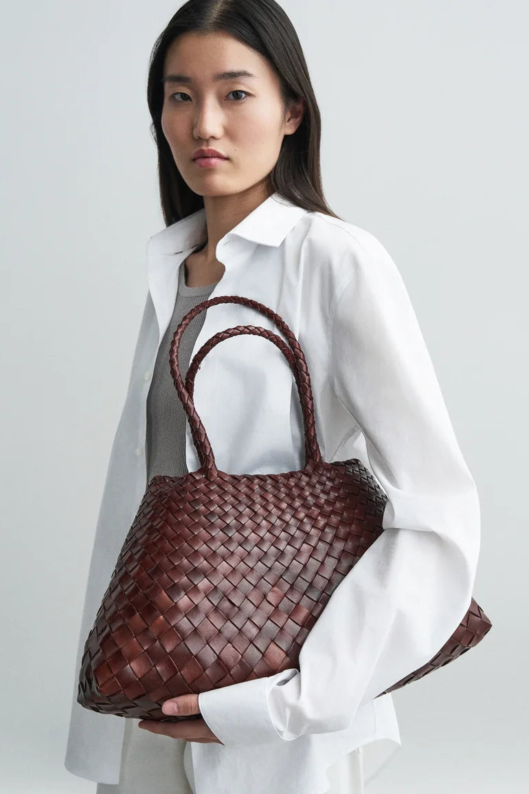 Model holding the Santa Croce Large Tote in bruciato.