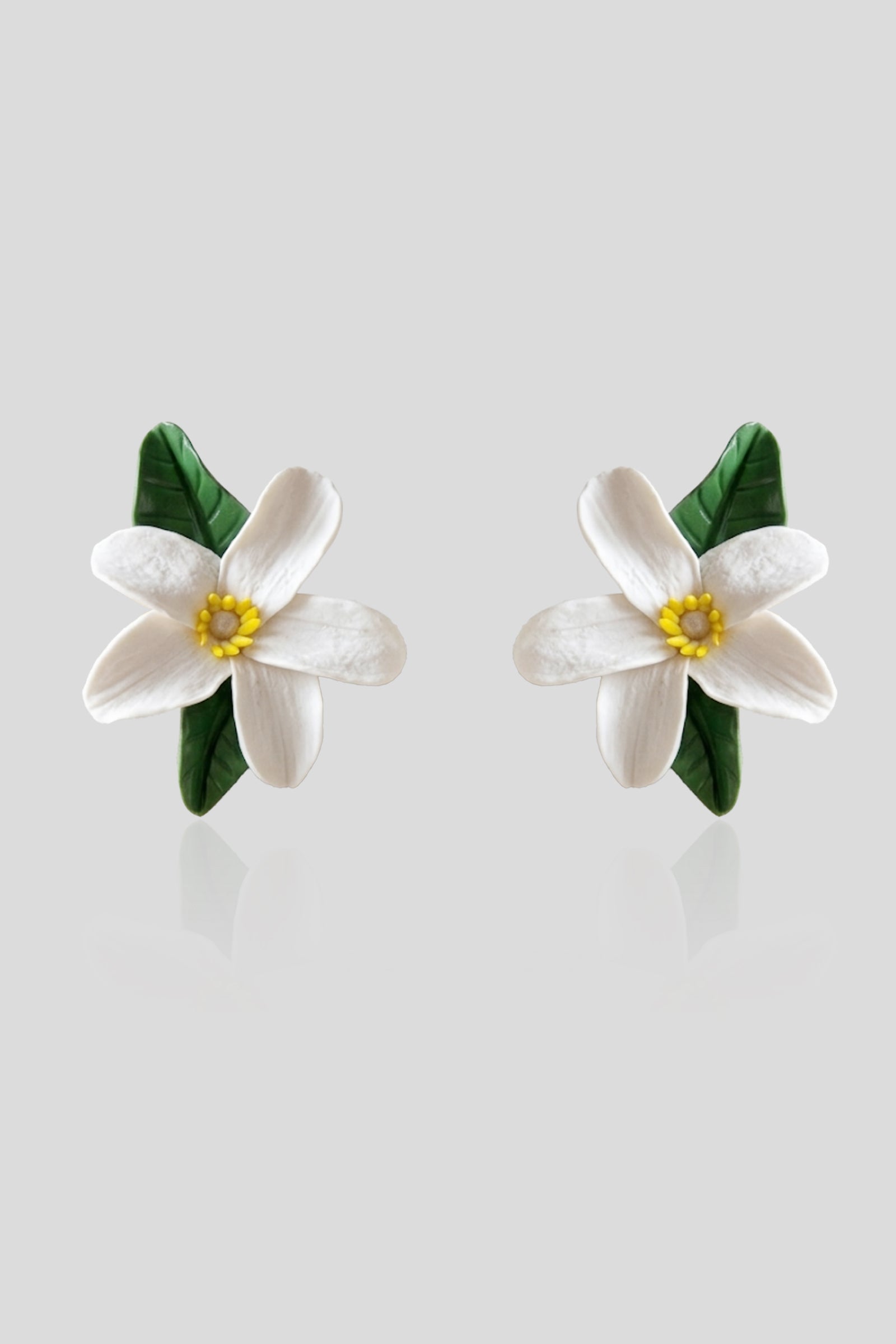 Handcrafted Neroli Vine Earrings featuring white floral blooms and sculpted green leaves in lightweight polymer clay.