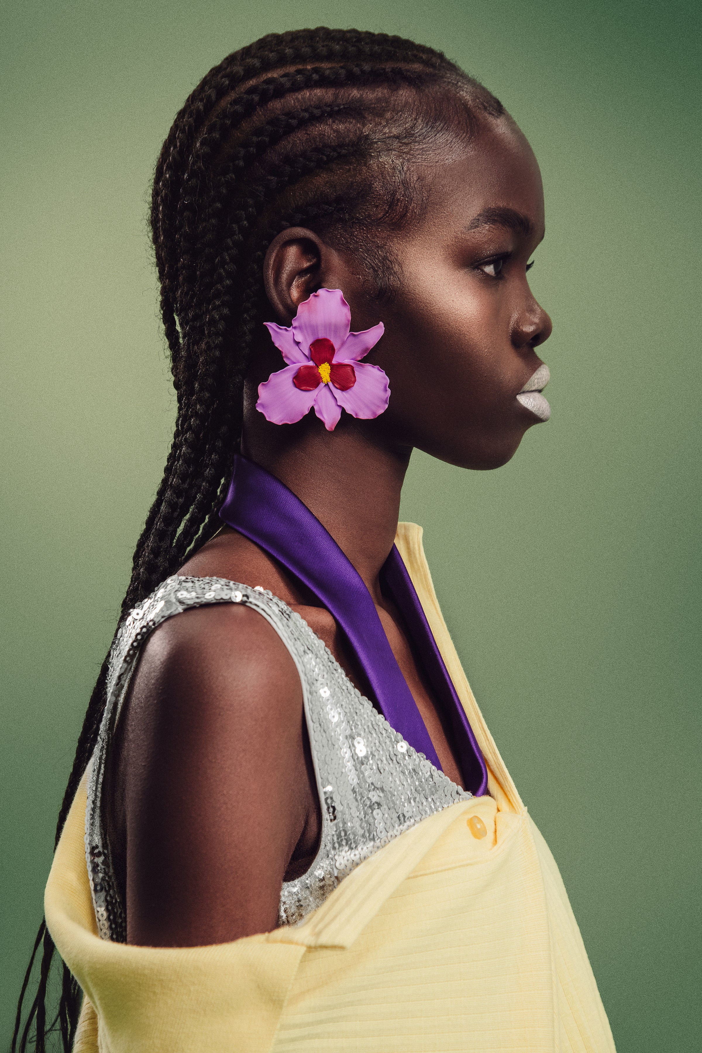 Side profile of model wearing handcrafted Mulberry Bloom Earrings in lilac and wine-red tones.