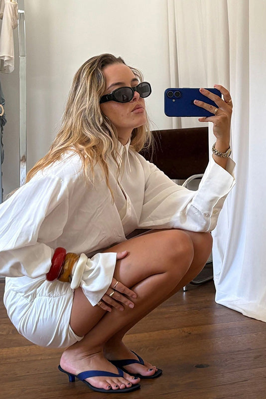 Senso Sonya blueberry flip flops styled with an oversized white shirt and tailored shorts mirror selfie