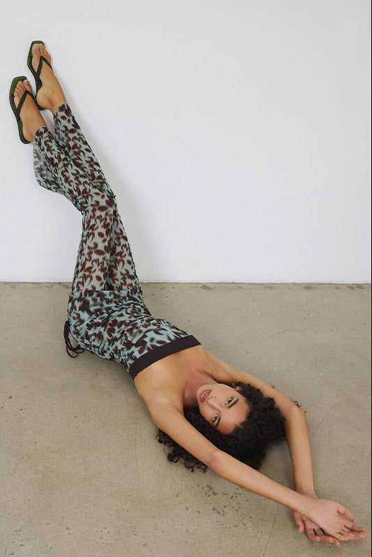 Senso Sonya olive flip flops styled with printed wide-leg trousers overhead editorial view