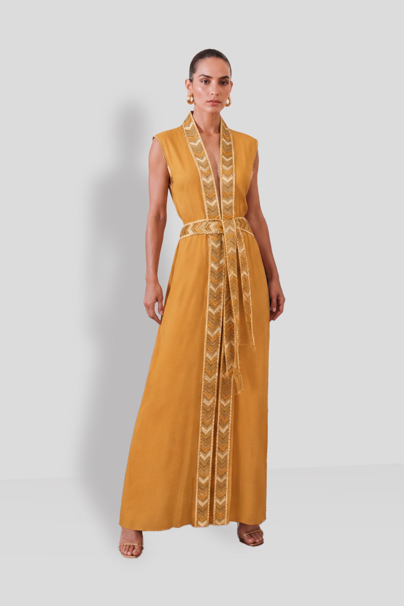 Natacha & Vanessa Thalie Dress in saffron with a deep V-neck, woven gold trim, and detachable braided rope belt.