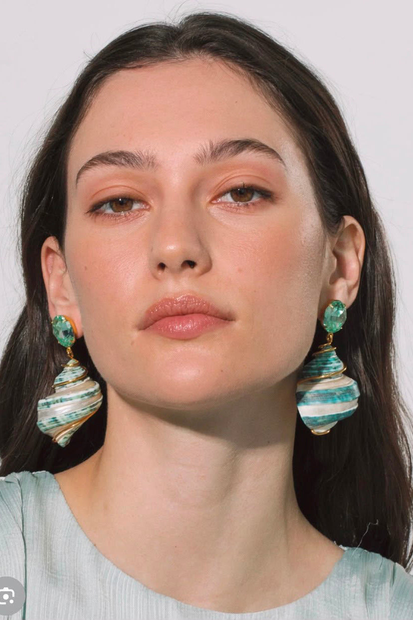 Front view of model wearing Jennifer Behr Wave Earrings with natural green spiral shell drop earrings