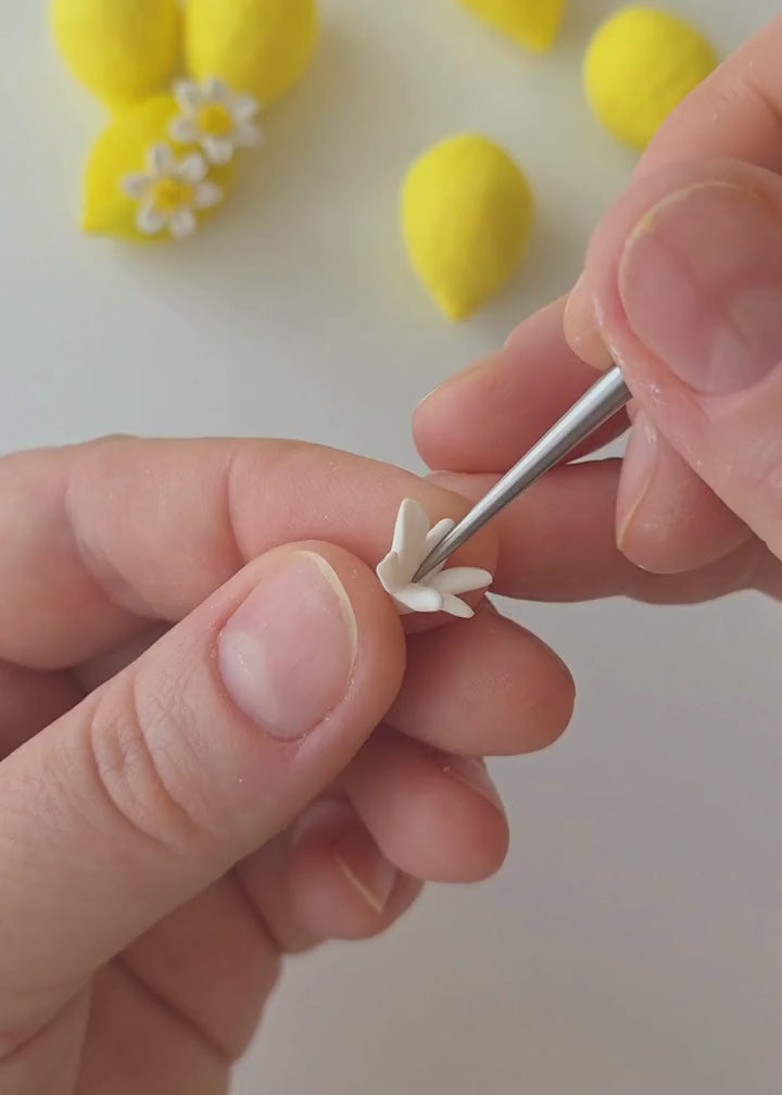 Behind the scenes of Jennifer Behr Limoncello Earrings handcrafted, showing the sculpting, hand-painting, and assembly of the lemon and flower statement earrings.