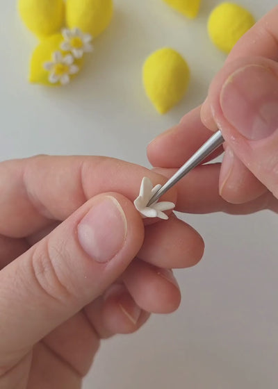 Behind the scenes of Jennifer Behr Limoncello Earrings handcrafted, showing the sculpting, hand-painting, and assembly of the lemon and flower statement earrings.