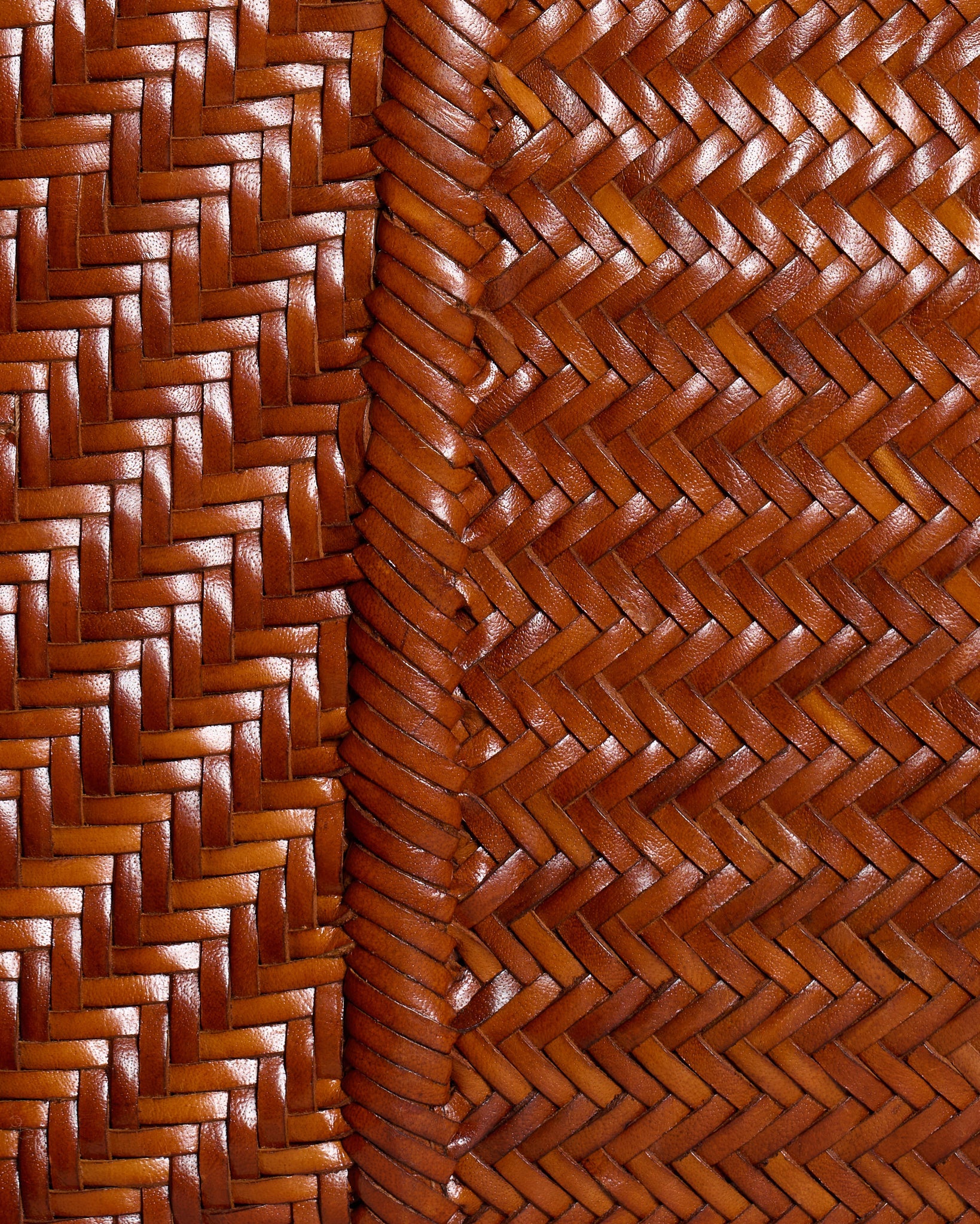 Close-up detail of the Vipera Pillow Cognac bag highlighting the intricate handwoven leather craftsmanship and texture.